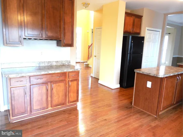 a kitchen with granite countertop wooden cabinets and a counter top space
