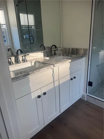 a bathroom with a double vanity sink and mirror