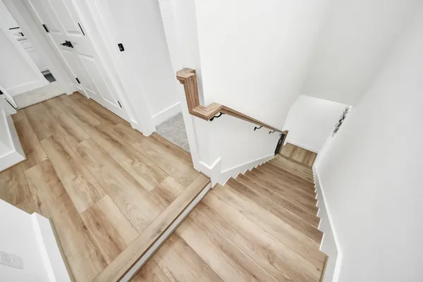 a view of staircase with white walls