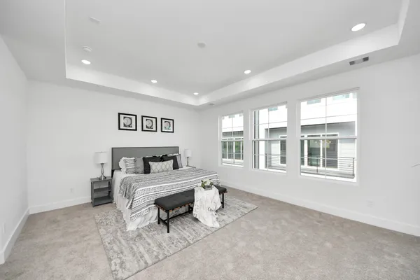 a bedroom with a bed and a large window