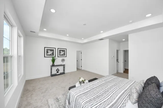 a bedroom with a bed and painting on the wall