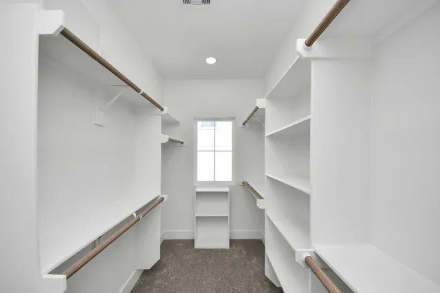 a hallway with stairs and a closet