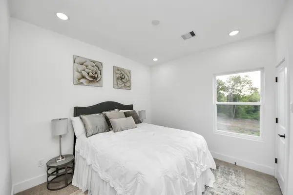 a bedroom with a bed and a window