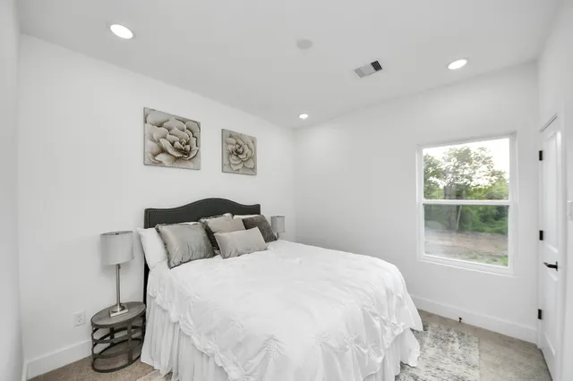 a bedroom with a bed and a window