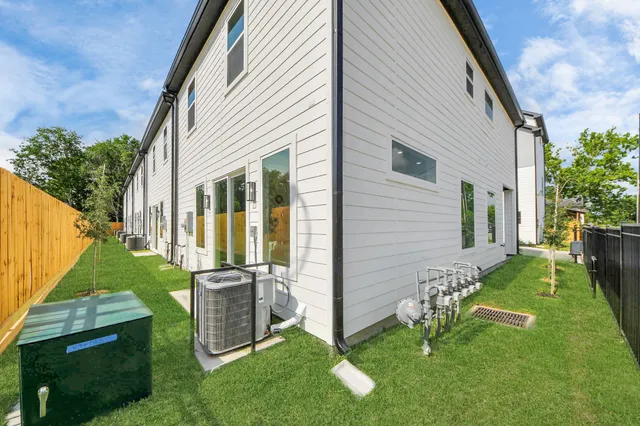 a view of backyard with barbeque grill and plants