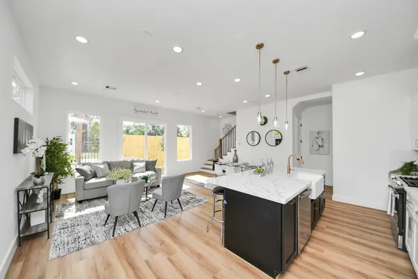 a large kitchen with a table and chairs