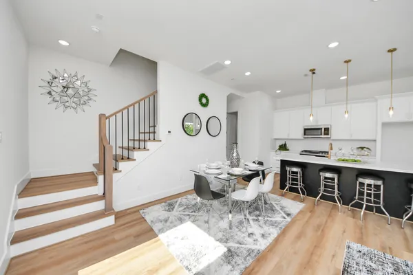 a large kitchen with a table and chairs