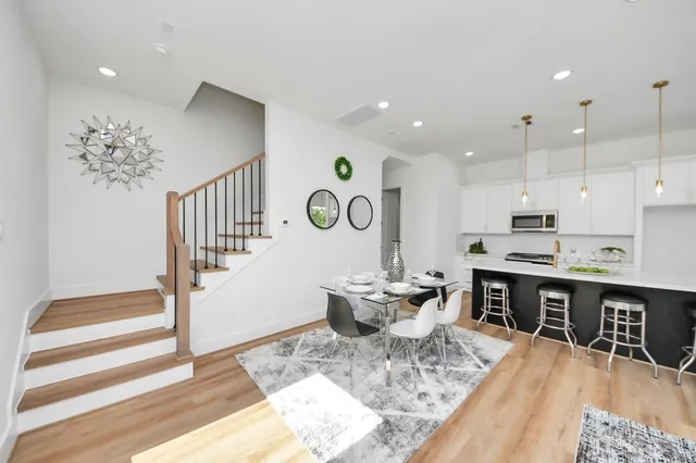 a large kitchen with a table and chairs