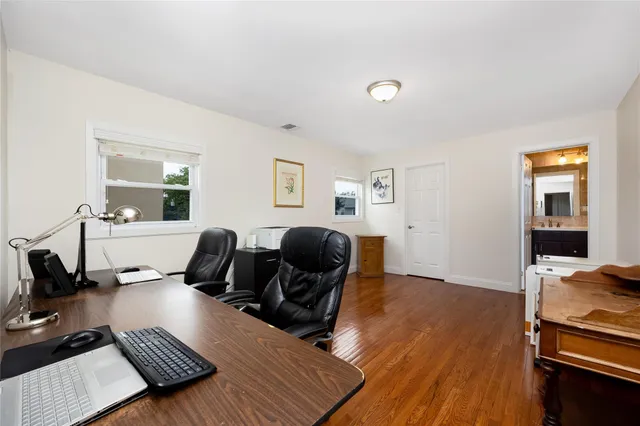a work room with furniture and wooden floor
