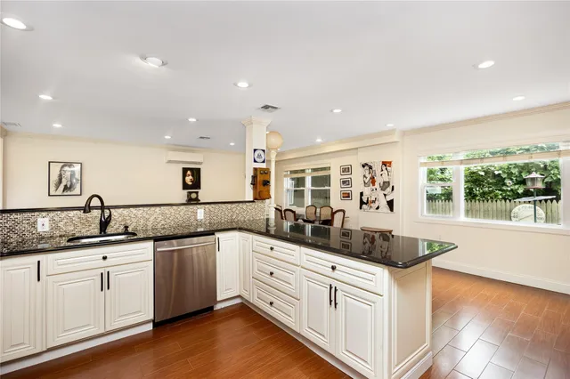 a kitchen with stainless steel appliances granite countertop a sink and cabinets