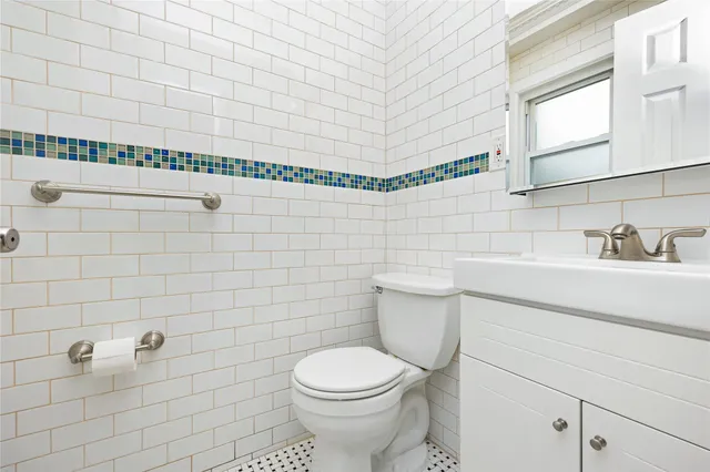 a bathroom with a toilet sink and mirror