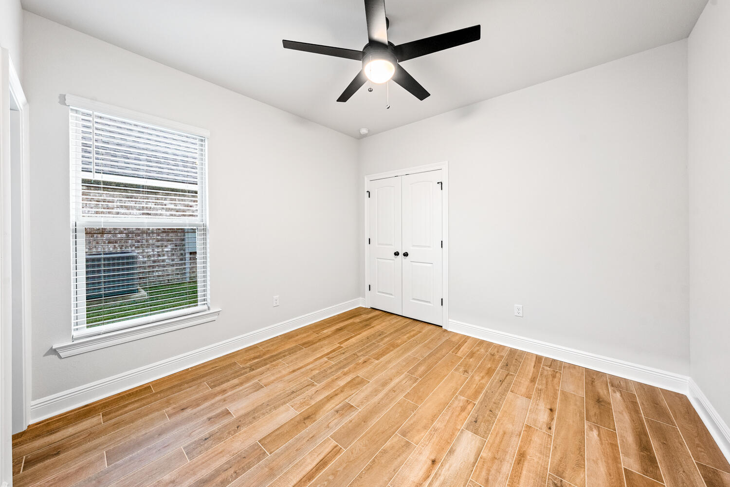 232 West Tweet Street Freeport, FL 32439 - Photo 15 of 23 a view of empty room with wooden floor and fan