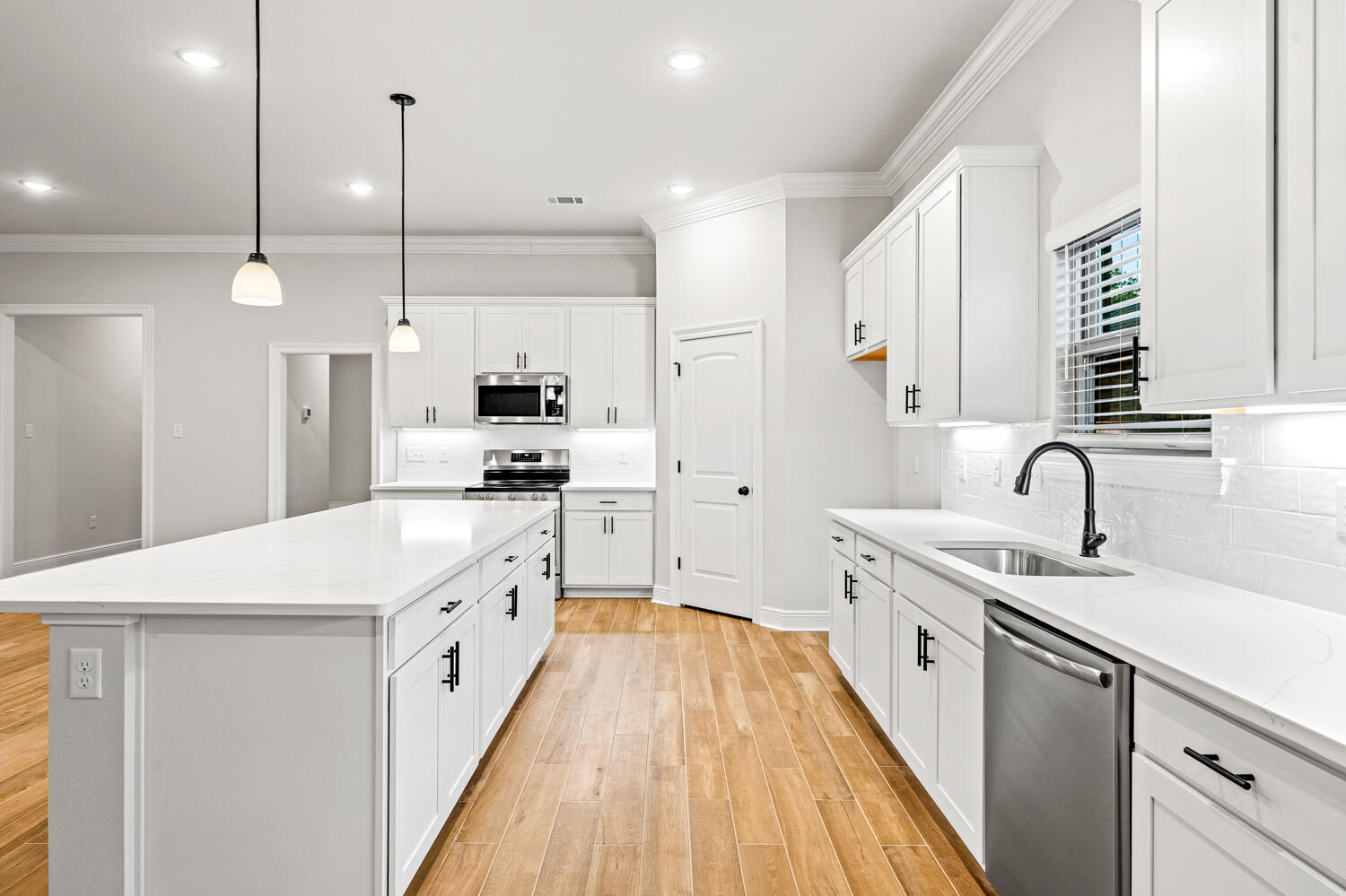 232 West Tweet Street Freeport, FL 32439 - Photo 3 of 23 a large kitchen with stainless steel appliances kitchen island a white cabinets and a chandelier