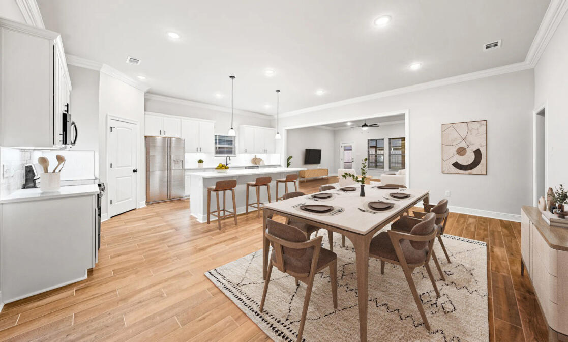 232 West Tweet Street Freeport, FL 32439 - Photo 5 of 23 a kitchen with stainless steel appliances kitchen island granite countertop a sink a stove a refrigerator cabinets and dining table