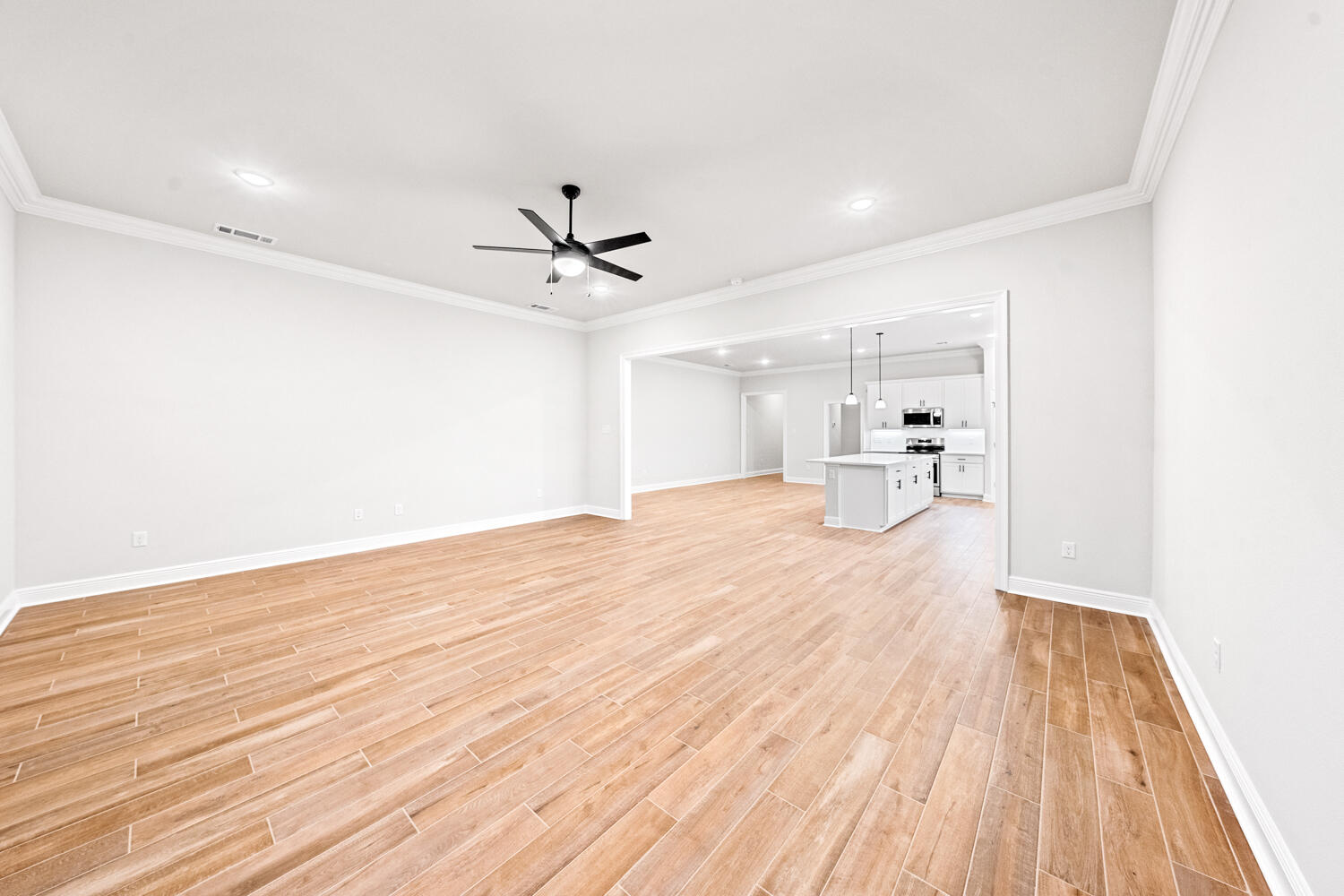 232 West Tweet Street Freeport, FL 32439 - Photo 8 of 23 a view of a room with wooden floor and a hallway