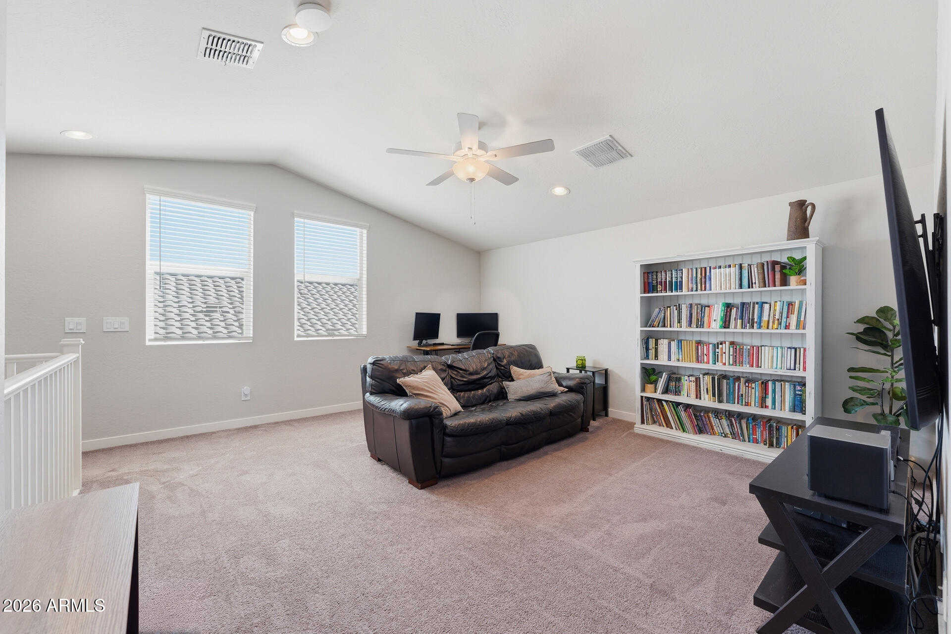 23069 East Mayberry Road Queen Creek, AZ 85142 - Photo 29 of 48 a living room with furniture and a book shelf