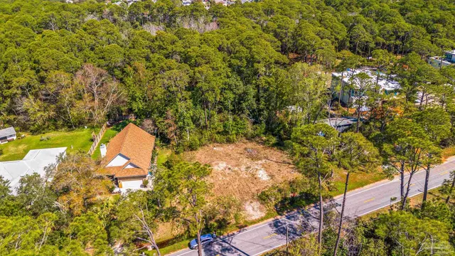 an aerial view of a house with a yard and garden