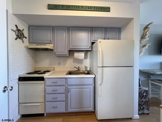 a kitchen with stainless steel appliances a refrigerator and a stove