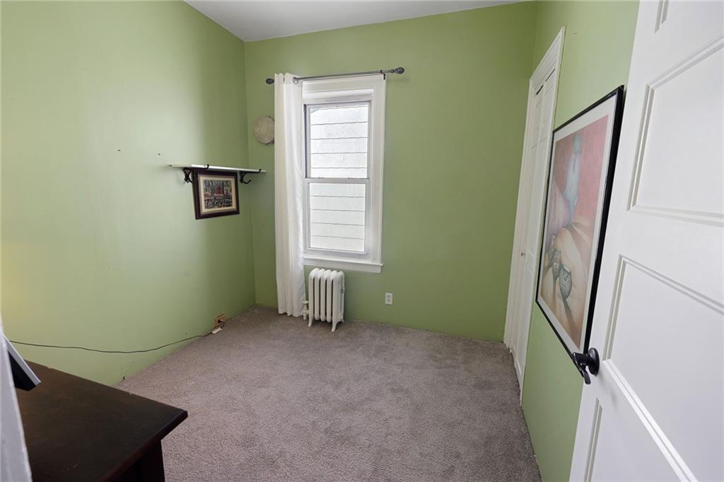 25 89th Street Brooklyn, NY 11209 - Photo 12 of 20 a room with window and a wooden floor