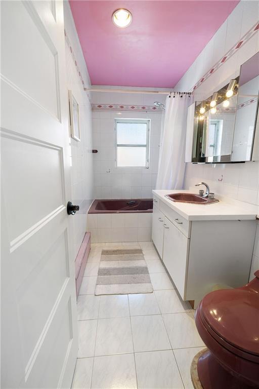 25 89th Street Brooklyn, NY 11209 - Photo 13 of 20 a bathroom with a sink a toilet and mirror
