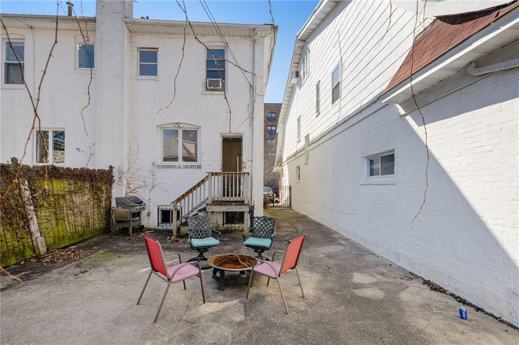 25 89th Street Brooklyn, NY 11209 - Photo 17 of 20 a backyard of a house with table and chairs