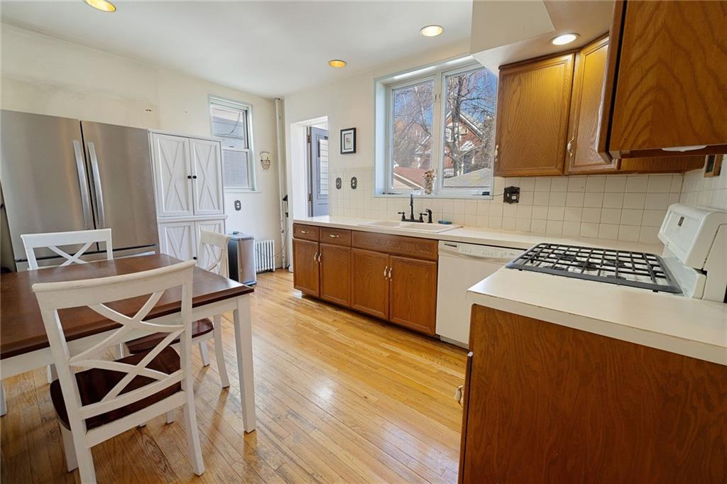 25 89th Street Brooklyn, NY 11209 - Photo 7 of 20 a kitchen with a stove a sink and a refrigerator
