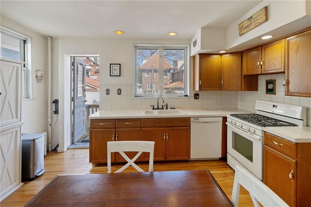 25 89th Street Brooklyn, NY 11209 - Photo 8 of 20 a kitchen with stainless steel appliances granite countertop a stove a sink and a refrigerator