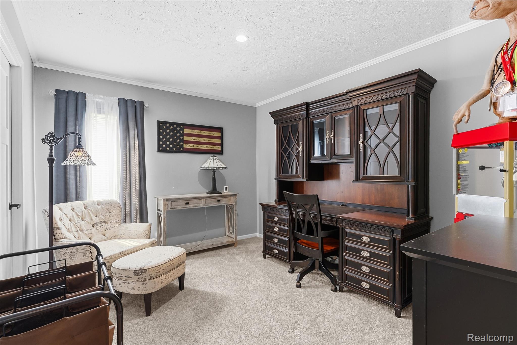 6450 Prince Boulevard Fenton, MI 48430 - Photo 24 of 31 Dedicated workspace featuring a built-in dark wood hutch with glass-front cabinetry and integrated desk
