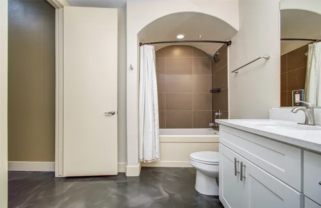 a bathroom with a toilet a sink and bathtub