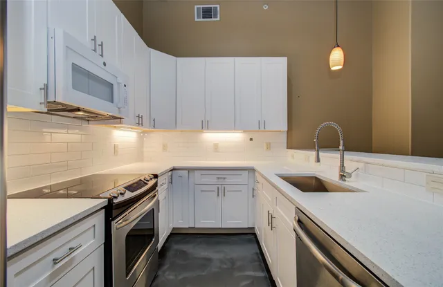 a kitchen with a sink and cabinets