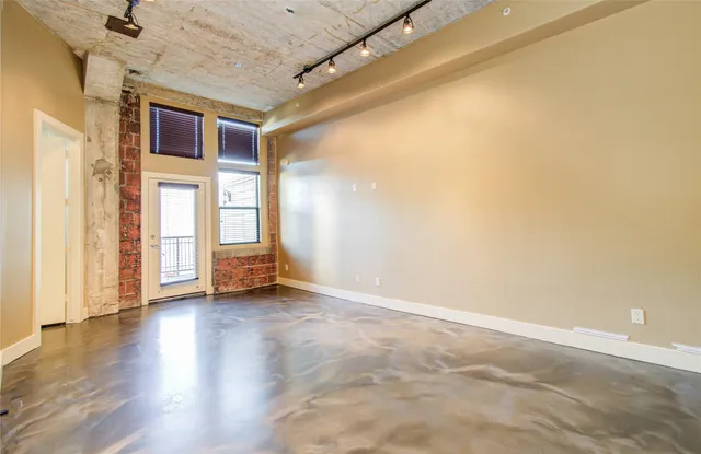a view of a livingroom with wooden floor and window