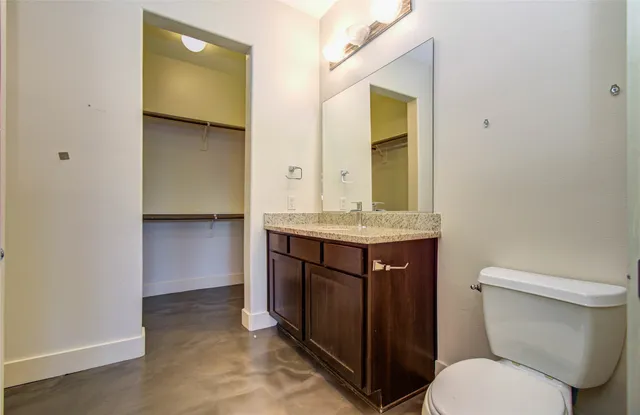 a bathroom with a sink vanity and toilet