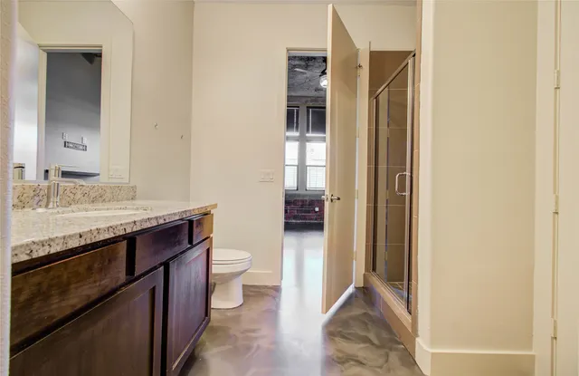 a spacious bathroom with a granite countertop sink and a mirror