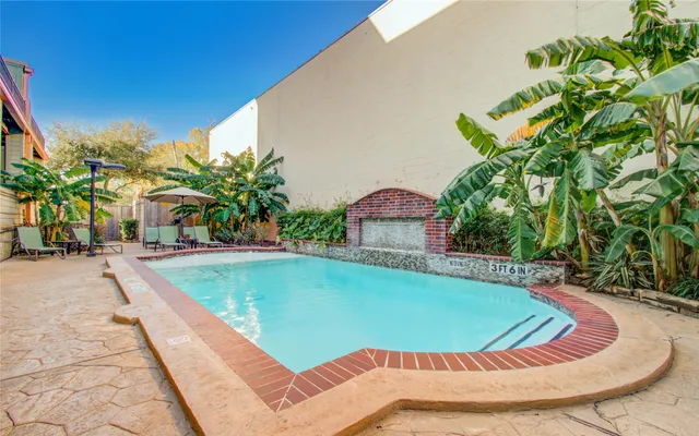 a view of a swimming pool with a patio