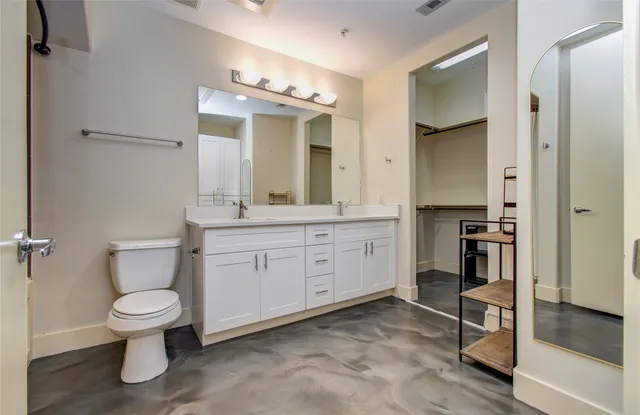 a spacious bathroom with a toilet sink and double
