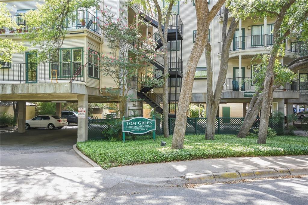 3115 Tom Green Street, Unit 404 Austin, TX 78705 - Photo 13 of 19 Multi-story condominium building featuring stucco siding, multiple balconies with dark railings, and exterior staircases