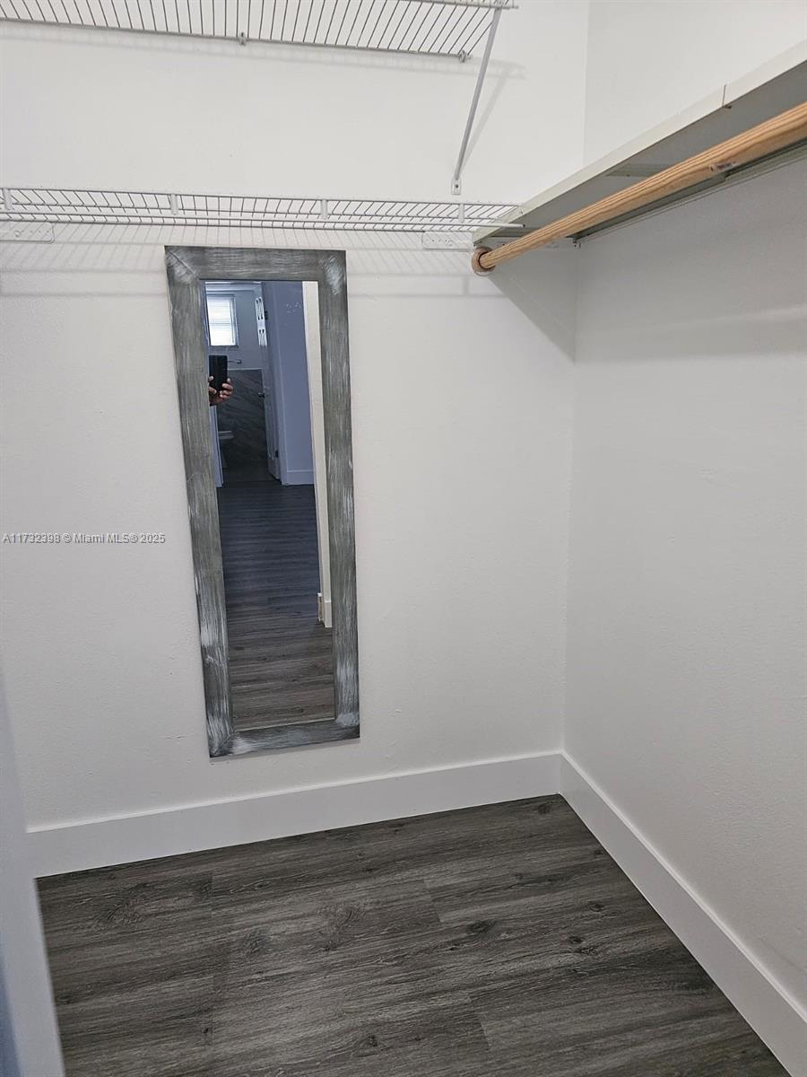 3777 Northwest 78th Avenue, Unit 3H Davie, FL 33024 - Photo 11 of 34 a view of an empty room with wooden floor and a window