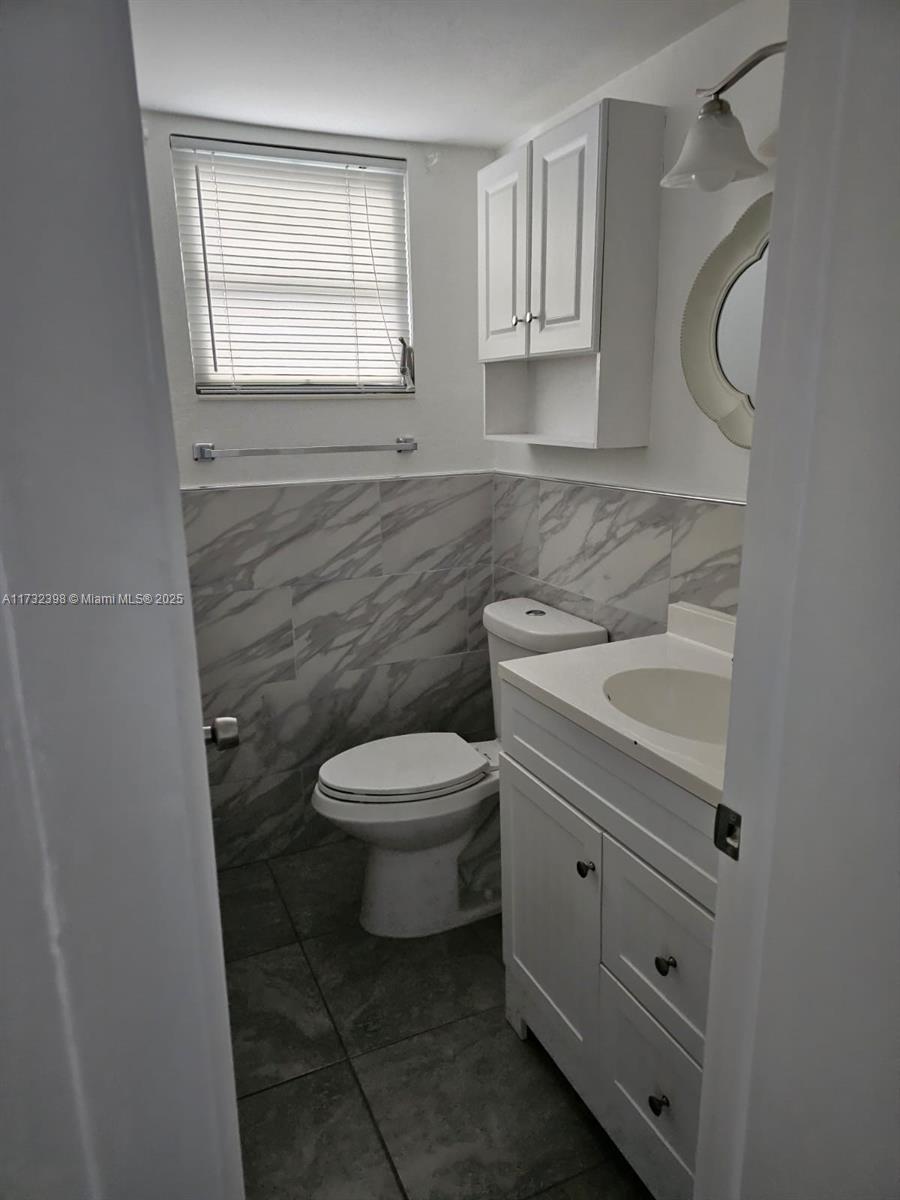 3777 Northwest 78th Avenue, Unit 3H Davie, FL 33024 - Photo 15 of 34 a bathroom with a sink a toilet and a window