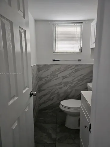 a bathroom with a toilet and a sink