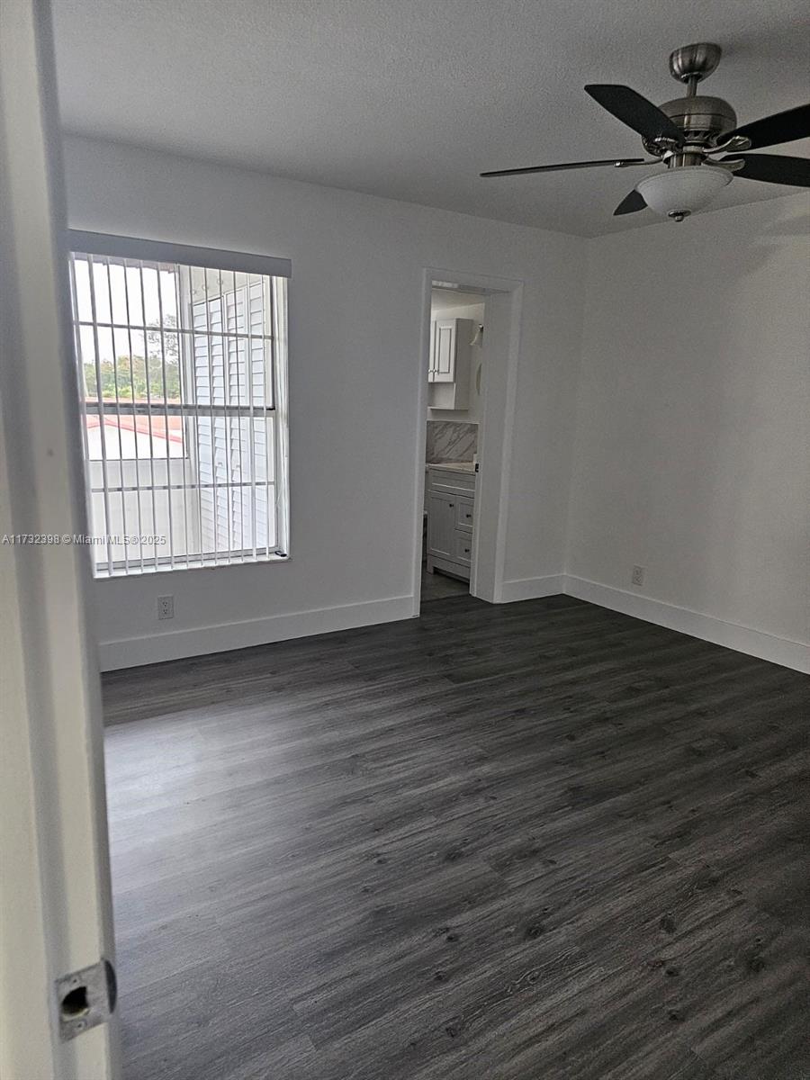 3777 Northwest 78th Avenue, Unit 3H Davie, FL 33024 - Photo 19 of 34 wooden floor in an empty room with a window