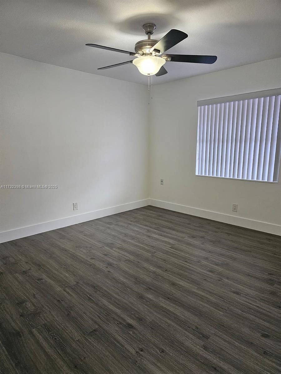 3777 Northwest 78th Avenue, Unit 3H Davie, FL 33024 - Photo 20 of 34 a view of an empty room with wooden floor and a window