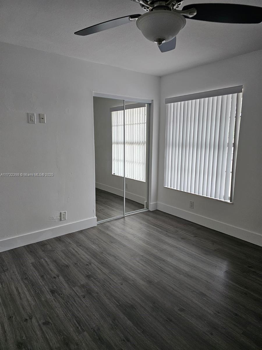 3777 Northwest 78th Avenue, Unit 3H Davie, FL 33024 - Photo 21 of 34 a view of an empty room with wooden floor and a window