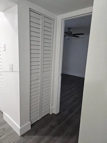 an empty room with wooden floor and closet