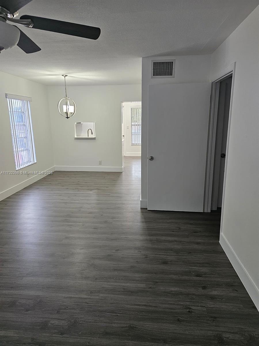 3777 Northwest 78th Avenue, Unit 3H Davie, FL 33024 - Photo 4 of 34 a view of a livingroom with an empty space wooden floor and window