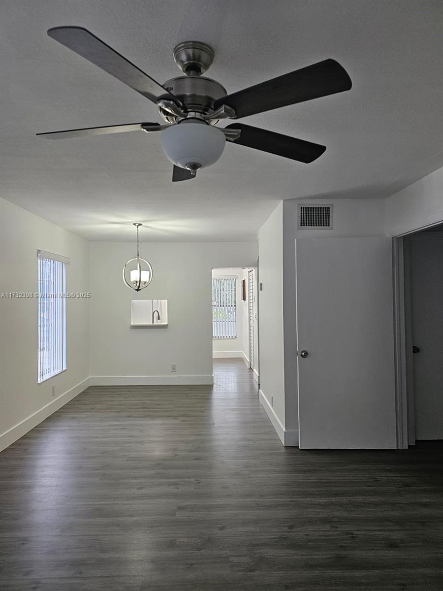 3777 Northwest 78th Avenue, Unit 3H Davie, FL 33024 - Photo 7 of 34 a view of a livingroom with a ceiling fan wooden floor and window