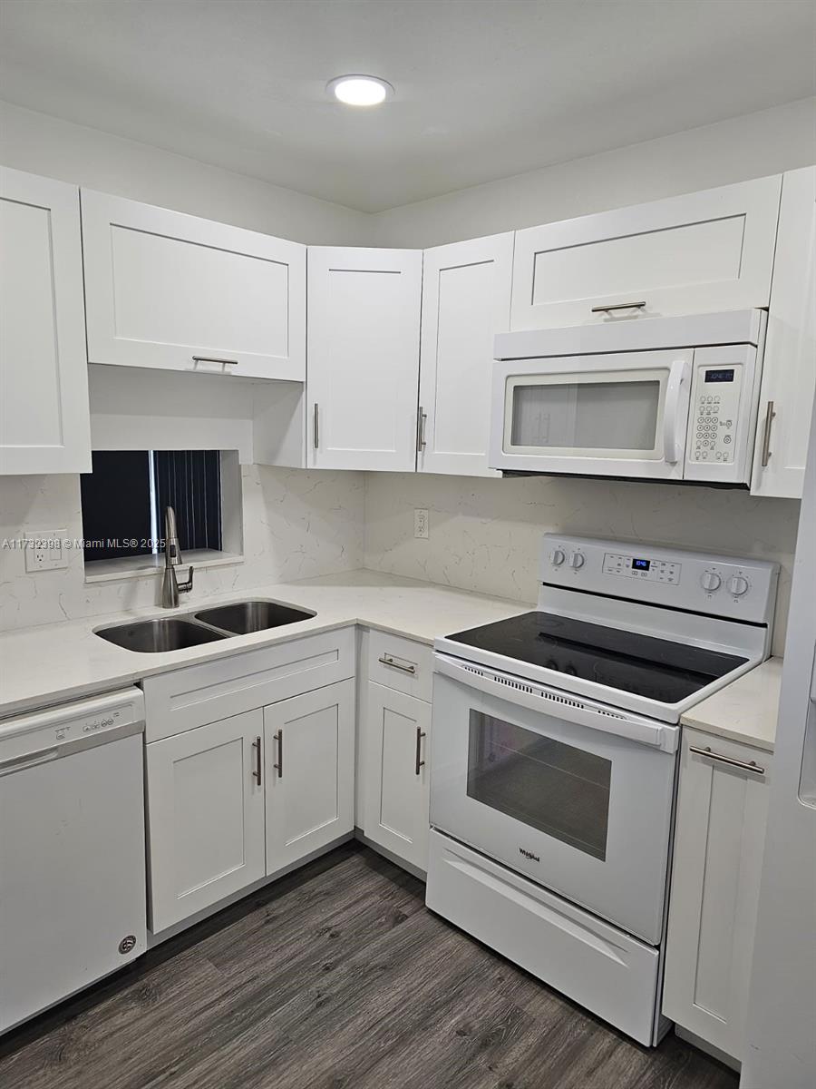 3777 Northwest 78th Avenue, Unit 3H Davie, FL 33024 - Photo 8 of 34 a kitchen with white cabinets and appliances