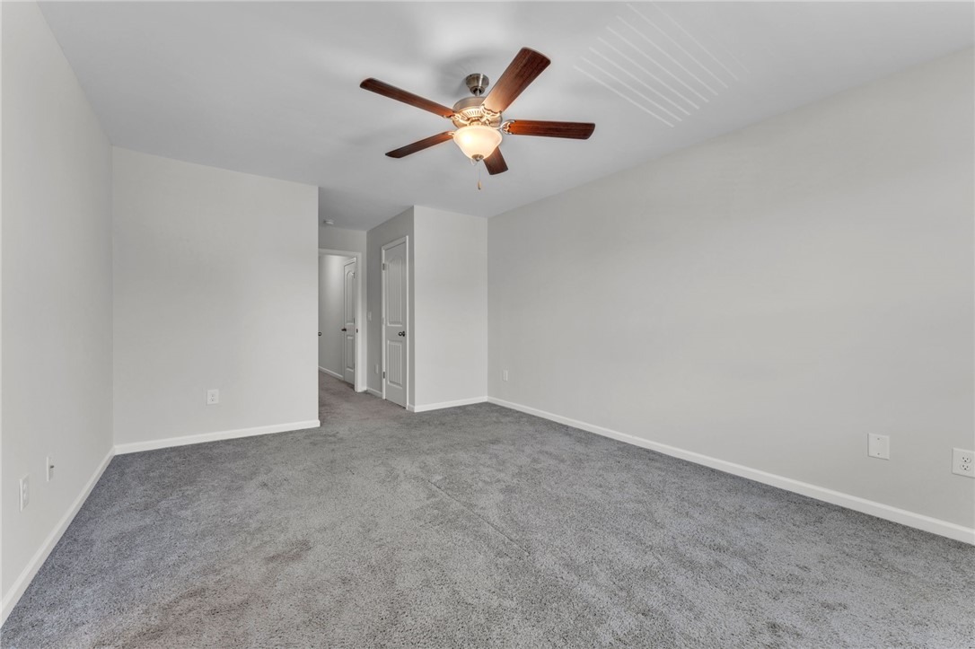 208 Samuel Street Pendleton, SC 29670 - Photo 13 of 32 An airy bedroom awaits, featuring comfortable carpet flooring and a ceiling fan for year-round comfort.