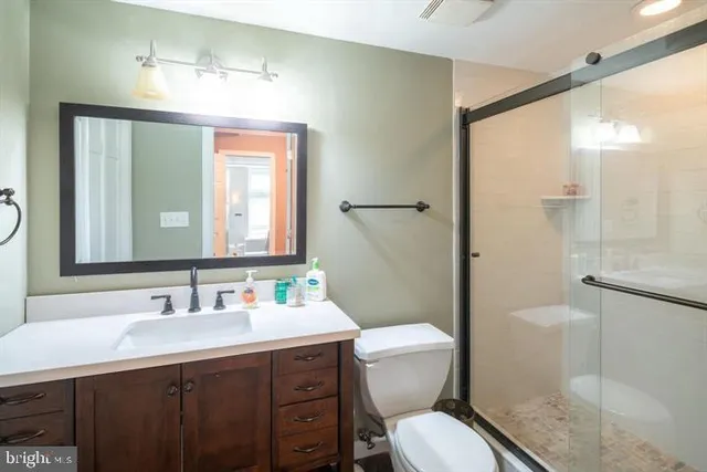 a bathroom with a toilet sink shower and mirror