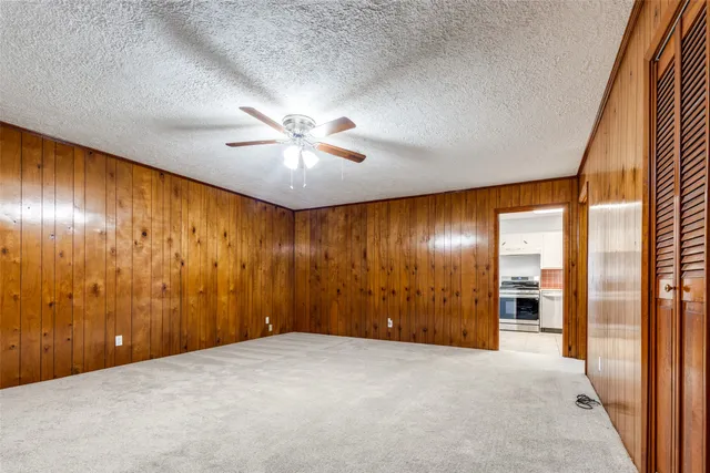 en empty room with a ceiling fan and window