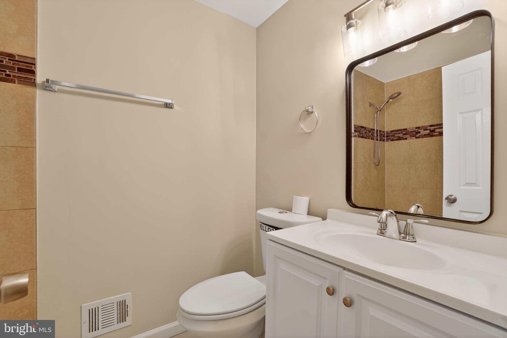1232 Palmer Road, Unit 111 Fort Washington, MD 20744 - Photo 28 of 45 a bathroom with a granite countertop sink toilet and shower